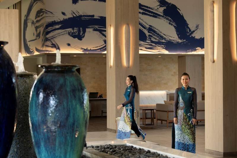 Meliá Ho Tram’s door women and waitresses don abstract interpretations of the iconic Vietnamese ao dai costume designed by Chula Fashion, turning many a holidaymaker’s head with captivating experiments in pattern and colour that also retain the feminine lines of the iconic garment. 