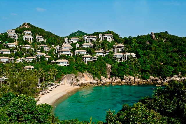 The resort is nestled into a cascading tropical landscape and has its own beach flanked by coral reefs.