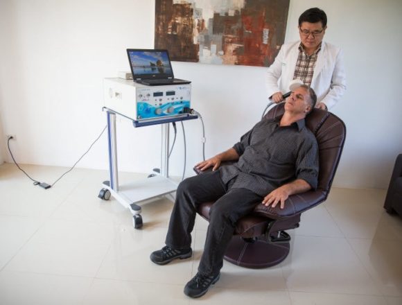 Dr Ngamwong administers TMS therapy to a client at The Dawn