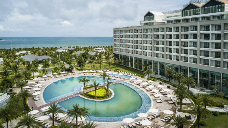 An immense tropical lagoon pool anchors Radisson Blu Resort Phu Quoc overlooking the Gulf of Thailand. 