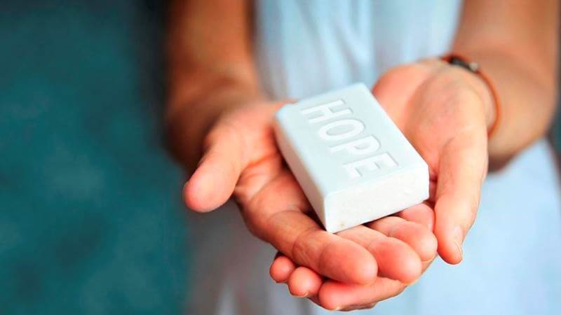 Diversey teaches the local people to use a simple cold-press method to recycle soap into reconstituted bars. The fresh soap is then distributed to communities lacking soap or sanitation.