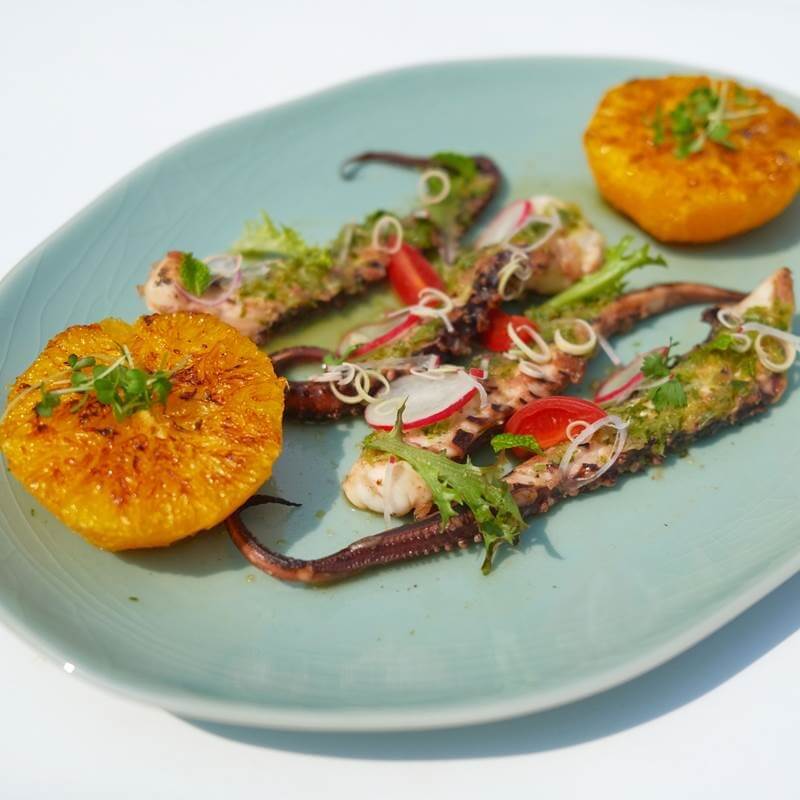 ‘Pla Muek Yang Som’ is grilled marinated octopus salad with caramelized Valencia orange, red radish and orange dressing