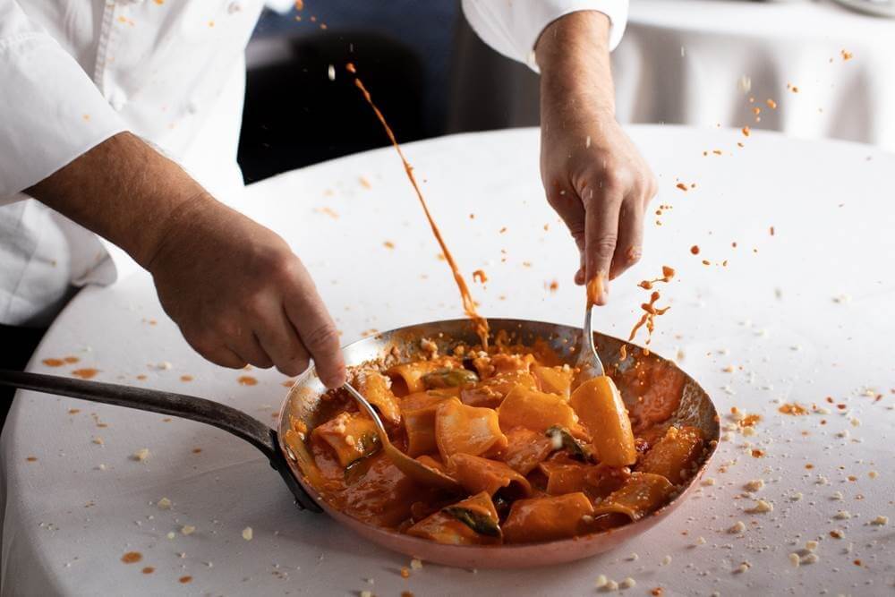 The restaurant’s signature “Vittorio Style Paccheri Pasta” features a rich, creamy tomato sauce that is warmed tableside in a copper pan