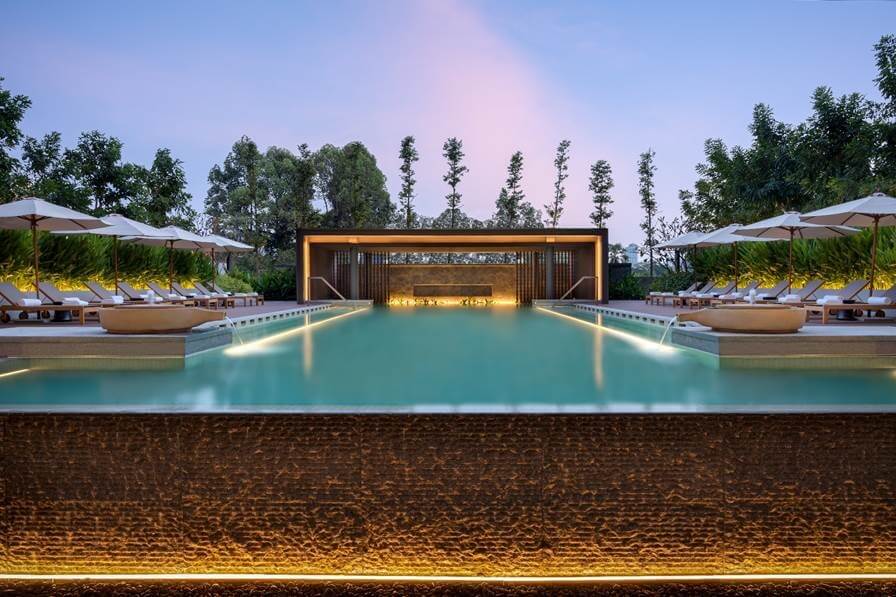 A 22-meter outdoor infinity pool surrounded by lush greenery is among the property’s leisure highlights