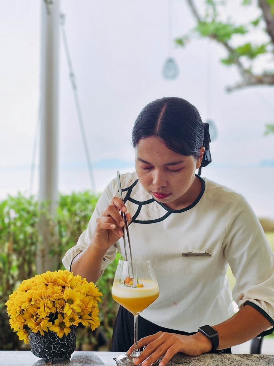 Dawadee Songprasert, affectionately known as 'Dao', prepares a cocktail at Banyan Tree Krabi's beachfront Kredkaew Bar.