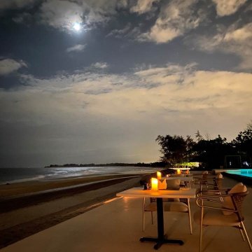 Softly lit tables overlook a pristine 5-kilometer stretch of white sand at Azerai Ke Ga Bay