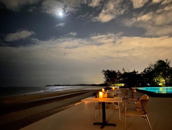 Softly lit tables overlook a pristine 5-kilometer stretch of white sand at Azerai Ke Ga Bay