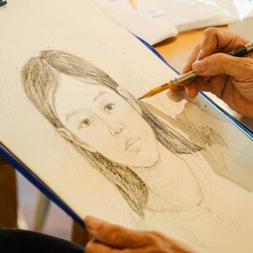 Talented Vietnamese Artist Sketches Guest Portraits at Alma Resort