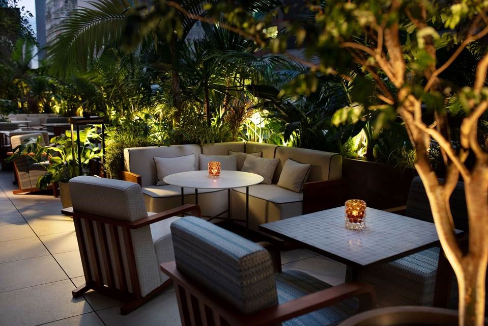 Adjacent to Zoku, The Terrace is an alfresco terrace bar framed by greenery.